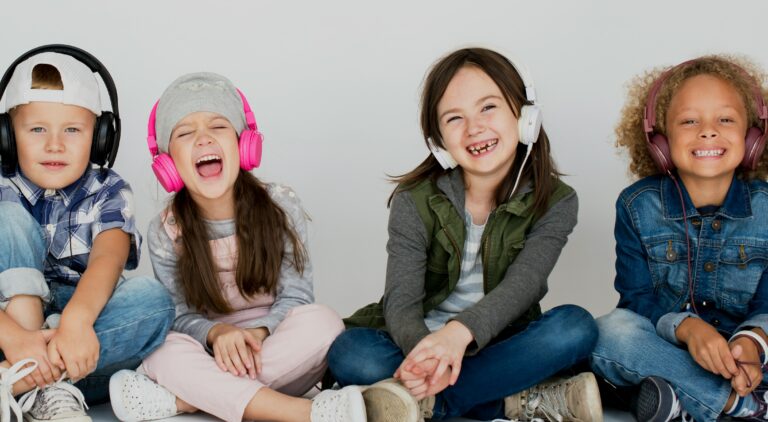 Child wearing volume-limiting headphones while using a tablet at a desk